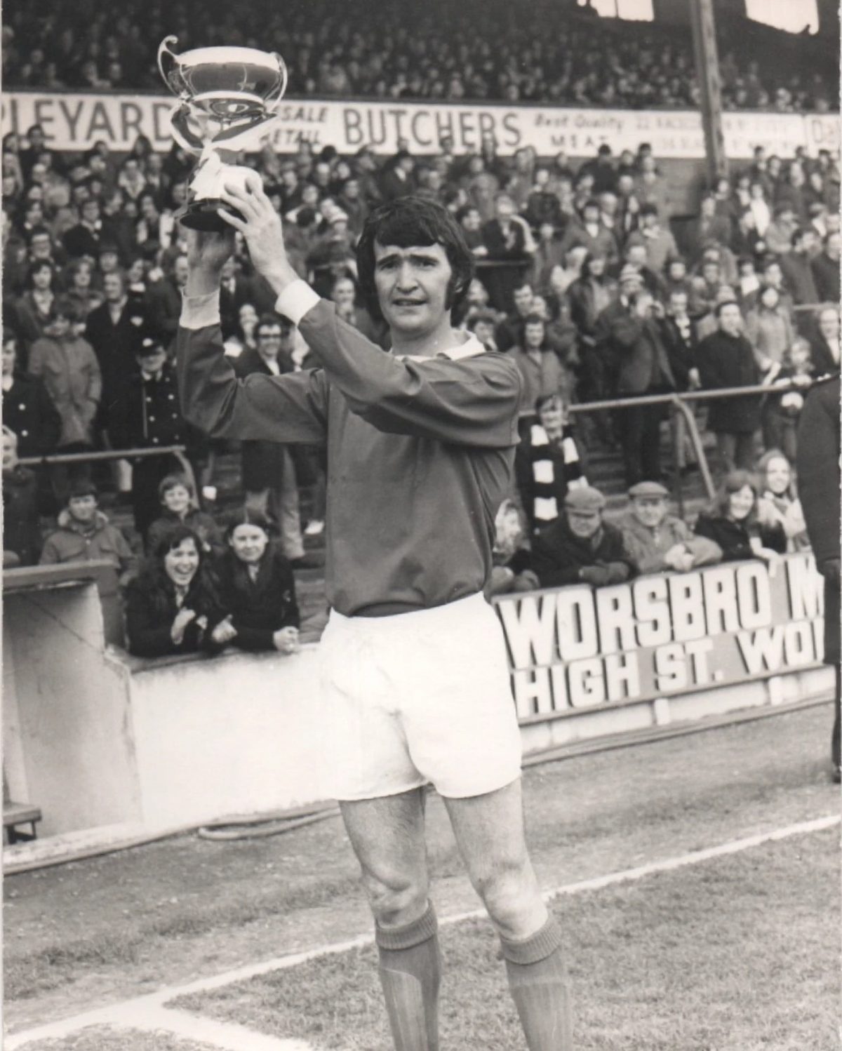Barry Murphy holding a trophy aloft in front of a packed crowd